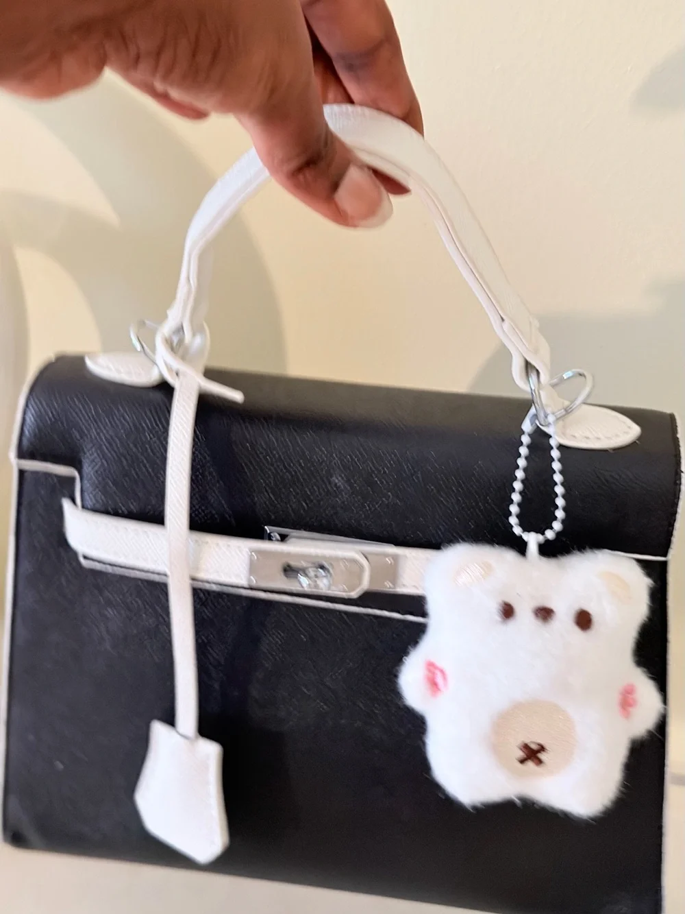 Black and White Structured Top-Handle Bag with Plush Charm